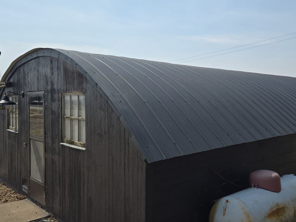 New Black Flex Metal Roof on Outdated Barrel Roof in Potosi WI image