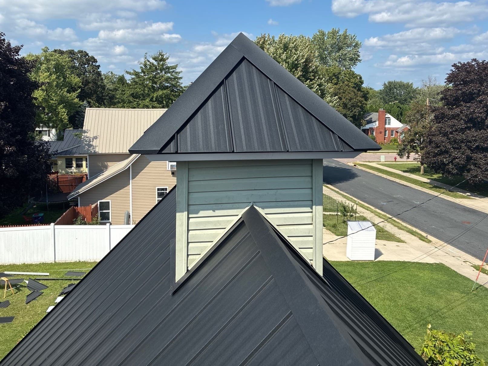 Asphalt Shingles Out, Black Standing Seam Metal Roof In image
