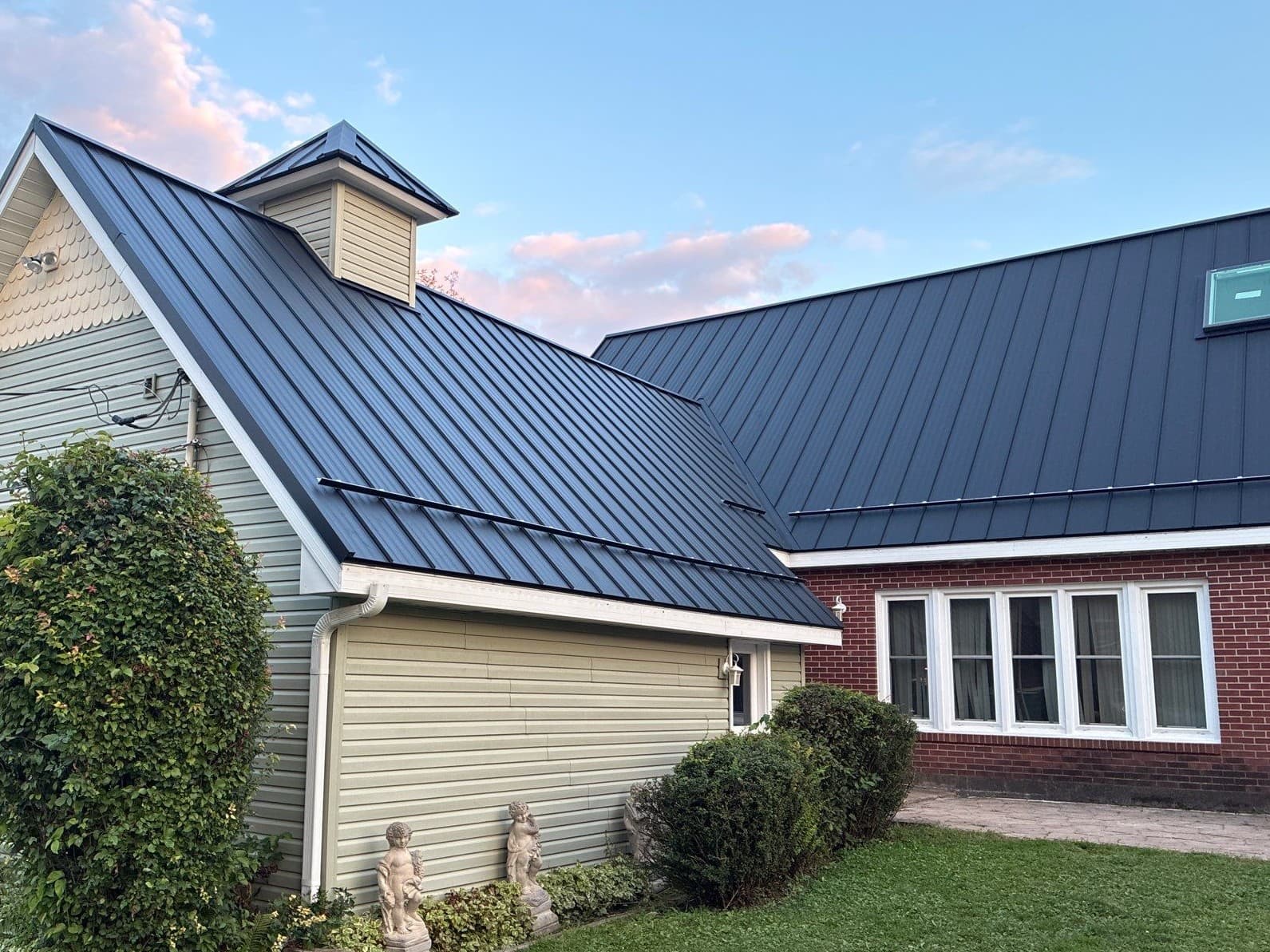 Gallery photos for Asphalt Shingles Out, Black Standing Seam Metal Roof In: Image #1