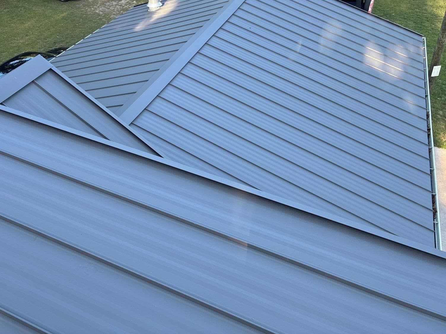 Shingles to Standing Seam Metal Roof on a Grand Marsh Log Home image